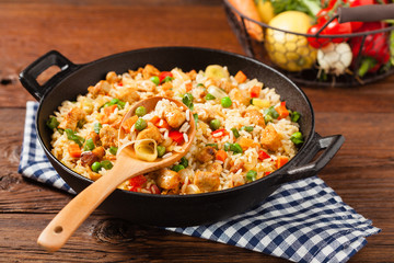 Fried rice with chicken. Prepared and served in a wok.
