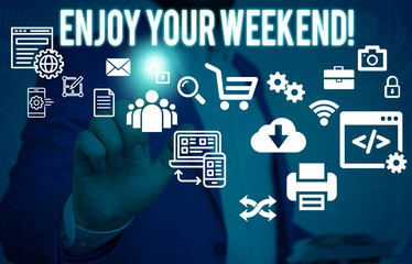 Conceptual hand writing showing Enjoy Your Weekend. Concept meaning wishing someone that something nice will happen at holiday Male human wear formal suit presenting using smart device