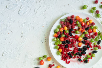 top view of a plate with lots of fresh raw berries