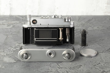 The old rangefinder film camera with on grey cement background.