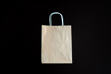 paper shopping bag levitating against the dark background copy space mockup