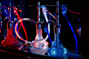 Plakat Multicolored hookah in the restaurant. Hookah elements on the background of the restaurant.