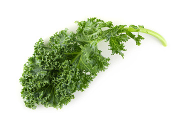 Fresh organic green kale leaves isolated over white background