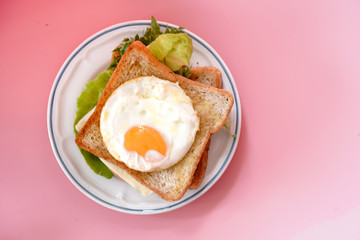 Whole wheat sandwich with eggs, fresh vegetables, ham and cheese, healthy breakfast for a new day that is happy and healthy.