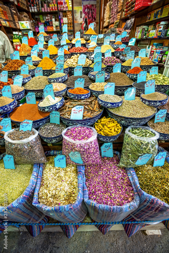 Wall mural 10/05/2019 kerman,.kerman province.iran, a huge variety of spices and herbs on a counter on a tradit