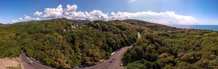 Air drone 360 view - on a mountain road near the village of Volkonka (South of Russia, the Caucasus) on a summer day. Not far away - the Black Sea