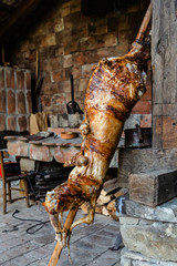 Close up on roasted lamb on the spit impaled cooked in traditional balkan cuisine