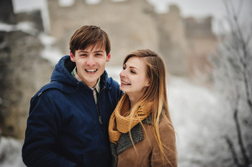 Fototapeta premium Happy couple having fun time outdoors in snow park. Winter vacation.