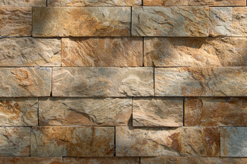 The texture of the wall is made of beige natural stone blocks.