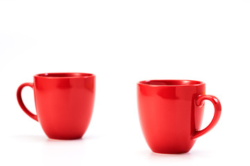 red ceramic mug on white background