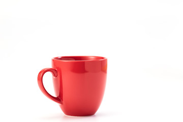 red ceramic mug on white background