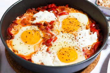 shakshuka fried eggs in a pan