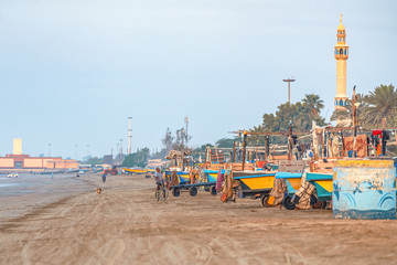 05/11/2019 Bandar Abbas, Hormozgan Province, Iran, many colorful fishing boats on the Persian Gulf coast stand at dawn and wait for the beginning of the working day.