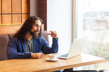 I need more. Portrait of handsome intelligence young adult man freelancer in casual style sitting...