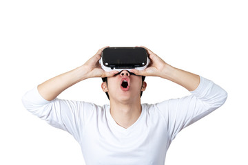 Young asian man in casual white outfit holding or wearing VR glasses by hands looking up above 360 degree feeling excited and amazed on isolated white background. Virtual reality experience concept.