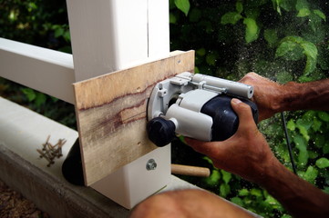 Dovetail joint. milling Woodworking and carpentry production.  a man's hands is working with a milling machine. Wooden beams spruce for outdoor construction, wood beams for carport. woodwork concept. 