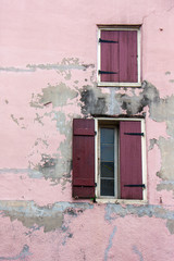 Fototapeta na wymiar Pink and Purple Windows Rustic Walls Shutter