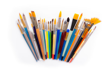 Colorful cosmetic brushes close up on white background
