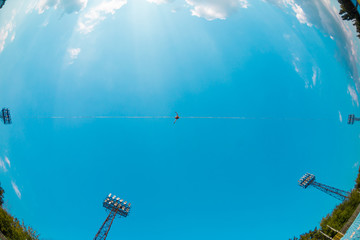 Highliner on the background of blue sky.