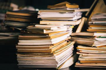 Stack of old books on wooden table, learning and education concepts. selective focus