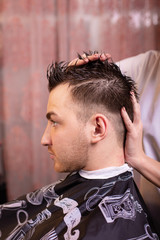 Close up of a male student having a haircut with hair clippers