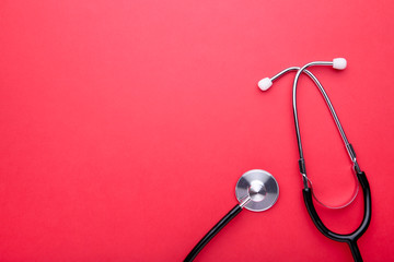 Medical stethoscope on a red background. Health care concept