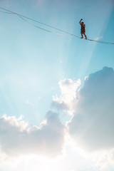 Highliner on the background of blue sky.