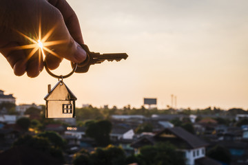 House model and key in home insurance broker agent ‘s hand or in salesman person. Real estate agent offer house, property insurance and security, affordable housing concepts