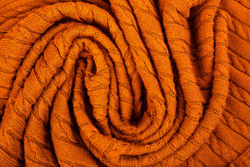 Fototapeta premium Crumpled knitted blanket. Soft and warm fabric crumpled in folds. Texture for background or illustrations.