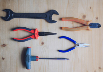 Tools on wooden background, top view