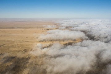 Coastal fog rolling over the desert landscape of Skeleton coast. Skeleton coast, Namibia.