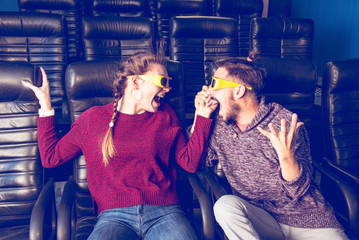 Plakat guy and girl 3d glasses are very worried while watching a movie in a cinema