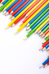 Fototapeta premium Many different colored pencils on a white background with a place for text and cory space .