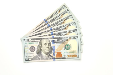 Six hundred dollars in hundred dollar bills on a white background. The view from the top.
