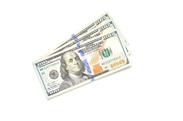 Three hundred dollars in bills of one hundred dollars lie on a white background. The view from the...