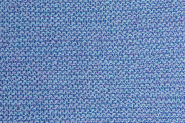 knitted blue fabric background with garter stitch pattern in shades of blue