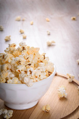 Salt popcorn on the wooden table, selective focus