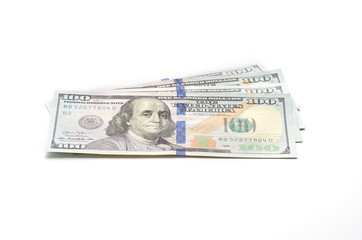 Four hundred dollars in bills of one hundred dollars lie on a white background.