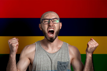 Emotions of anger and indignation. The man in glasses clenched his hands into fists and shouted. In...