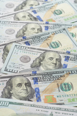 Background from chaotically lying of notes for one hundred dollars.