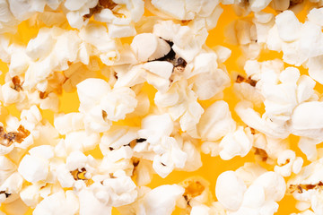 Scattered popcorn over yellow background