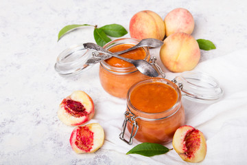 Homemade peach jam with organic fruit. Sweet preserves on a light background, , copy space