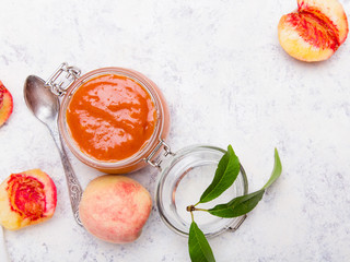 Homemade peach jam with organic fruit. Sweet preserves on a light background, , copy space