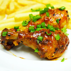 Chicken legs with french fries potatoes