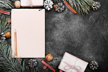 Christmas background with blank notebook surrounded by Christmas decorations. Letter to Santa or Christmas shopping list