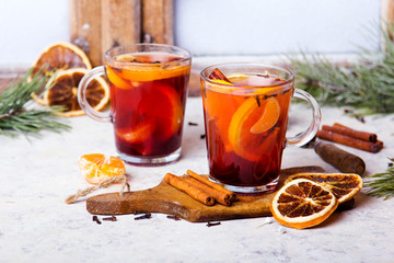 Christmas drink, mulled wine with orange, cinnamon and cloves on white background