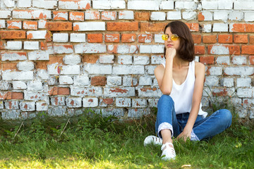 Serious Teenage girl in yellow glasses. Copy space.