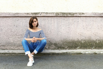 Young dreaming girl portrait. Old vintage wall, copy space.