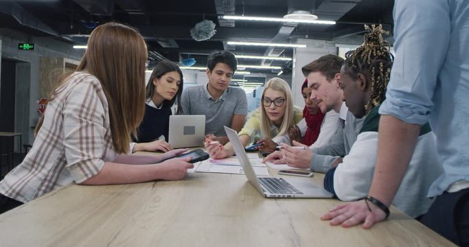 Young multiethnic business team of software developers working together using