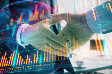 Multi exposure of financial chart and map on office background with two businessmen handshake. Concept of success in business